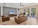 Open concept living room with tile floors, a ceiling fan and access to the outside patio at 1219 Thornbury Dr, Parrish, FL 34219