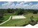 Community recreation area with a sand volleyball court and walking paths amidst the green landscape at 1219 Thornbury Dr, Parrish, FL 34219