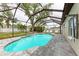 Gorgeous screened-in pool with sun loungers and a connected hot tub at 12319 Hollybush Ter, Lakewood Ranch, FL 34202
