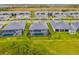 Aerial view of homes with screened-in pools in a well-planned community with lush landscaping at 12557 Galapagos Ct, Venice, FL 34293