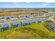 Aerial view of a neighborhood featuring new homes, mature trees, and well-maintained green spaces at 12557 Galapagos Ct, Venice, FL 34293