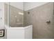 Large shower with glass enclosure with neutral tiles and brushed metal fixtures at 12557 Galapagos Ct, Venice, FL 34293