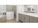 Beautiful bathroom featuring double vanity, bathtub, and large glass enclosed shower at 12557 Galapagos Ct, Venice, FL 34293