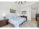 Bright bedroom with a calming coastal theme, featuring a queen bed, stylish art, and sleek furnishings at 12557 Galapagos Ct, Venice, FL 34293