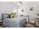Comfortable bedroom with light decor, a cozy bed, and natural light from the window at 12557 Galapagos Ct, Venice, FL 34293