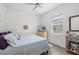 Cozy bedroom with a bright ambiance, a ceiling fan, and light wood floors at 12557 Galapagos Ct, Venice, FL 34293