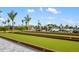 Outdoor bocce ball court with manicured turf and beautiful landscaping at 12557 Galapagos Ct, Venice, FL 34293
