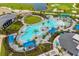 Expansive community pool area with lounge chairs, cabanas, and lush tropical landscaping at 12557 Galapagos Ct, Venice, FL 34293