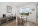 Cozy dining area with a round table, four chairs, and natural light from the window at 12557 Galapagos Ct, Venice, FL 34293