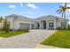 Beautifully landscaped single-story home with a tile roof and a three-car garage at 12557 Galapagos Ct, Venice, FL 34293