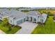 Beautiful single-story home with a gray tile roof, a three-car garage, and a lush green lawn at 12557 Galapagos Ct, Venice, FL 34293