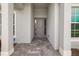 Covered front entrance with stone pavers and modern architectural details at 12557 Galapagos Ct, Venice, FL 34293