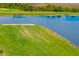 Scenic view of the golf course featuring a lush green fairway, water hazard, and sand trap at 12557 Galapagos Ct, Venice, FL 34293