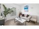 Bright living room with beachy decor, white sofa, marble coffee table, and tiled floors at 12557 Galapagos Ct, Venice, FL 34293