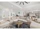 Open-concept floor plan with a large sectional sofa and a view of the kitchen at 12557 Galapagos Ct, Venice, FL 34293