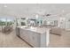 Open-concept living space with a gourmet kitchen, dining area, and comfortable seating arrangement at 12557 Galapagos Ct, Venice, FL 34293