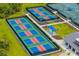 Aerial view of outdoor pickleball courts with blue and red playing surfaces at 12557 Galapagos Ct, Venice, FL 34293