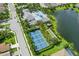 Aerial view showcasing the community's pool, tennis courts, bocce ball, and lakeside setting at 13603 Deep Blue Pl, Bradenton, FL 34211