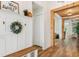 Inviting entryway with wood-look floors, bench seating, coat hooks, and views through to the living spaces at 13603 Deep Blue Pl, Bradenton, FL 34211