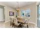 Charming dining room featuring rustic table and modern chandelier and view to outside patio at 14277 Skipping Stone Loop, Parrish, FL 34219