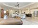 Open-plan living room looking into kitchen with island, cooktop and stainless-steel fridge at 14277 Skipping Stone Loop, Parrish, FL 34219