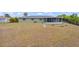 Expansive backyard featuring a screened-in porch and fire pit area at 1665 Harmony Dr, Port Charlotte, FL 33952
