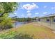 Spacious backyard with waterfront view and chain link fence at 1665 Harmony Dr, Port Charlotte, FL 33952