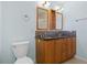 Bathroom featuring double sink vanity, wood cabinets and modern fixtures at 1665 Harmony Dr, Port Charlotte, FL 33952