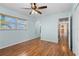 Cozy bedroom with wood floors, ceiling fan and plenty of natural light at 1665 Harmony Dr, Port Charlotte, FL 33952