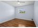 Bedroom with laminated wood floor, a ceiling fan, a window and a white wall at 1665 Harmony Dr, Port Charlotte, FL 33952
