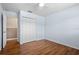 Bedroom with laminate wood floor, closet, ceiling fan, base trim, and light blue walls at 1665 Harmony Dr, Port Charlotte, FL 33952