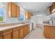 Bright kitchen featuring wooden cabinets, tile flooring, and modern appliances for a functional cooking space at 1665 Harmony Dr, Port Charlotte, FL 33952
