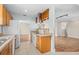 Bright kitchen featuring wood cabinets, modern appliances, and an open layout into the living area at 1665 Harmony Dr, Port Charlotte, FL 33952