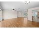 Large living room with wood floors, ceiling fan, and open access to the kitchen area at 1665 Harmony Dr, Port Charlotte, FL 33952