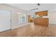 Open-concept living area with wood flooring and a view into the kitchen at 1665 Harmony Dr, Port Charlotte, FL 33952