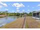 Backyard waterfront view with tropical vegetation and blue skies at 1665 Harmony Dr, Port Charlotte, FL 33952