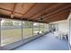 Spacious screened lanai with outdoor seating area and a view of the fenced backyard at 207 62Nd W St, Bradenton, FL 34209