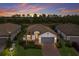 Charming single Gathering home features well-maintained landscaping, a two-car garage, and a lovely tile roof at 20892 Cattail Blvd, Venice, FL 34292