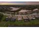 Stunning aerial view of homes with pools surrounded by lakes at sunset at 20892 Cattail Blvd, Venice, FL 34292