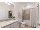 Bathroom features a shower-tub combo, granite vanity top and neutral walls and floors at 20892 Cattail Blvd, Venice, FL 34292