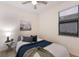 Cozy bedroom features a ceiling fan, a sailboat art piece, and natural light from the window at 20892 Cattail Blvd, Venice, FL 34292