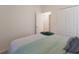 Bright bedroom featuring neutral walls, white bedding, and a large closet at 20892 Cattail Blvd, Venice, FL 34292