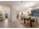 Open-concept dining area showcases a modern table and view of the home's entryway at 20892 Cattail Blvd, Venice, FL 34292