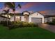Beautiful home with a two-car garage, a tile roof, nice landscaping, and attractive exterior paint at 20892 Cattail Blvd, Venice, FL 34292
