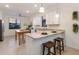 Bright kitchen featuring granite countertops, a breakfast bar with seating, and stainless steel appliances at 20892 Cattail Blvd, Venice, FL 34292