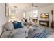 Spacious living room with modern decor, comfortable seating, and a view into the kitchen at 20892 Cattail Blvd, Venice, FL 34292