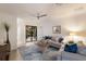 Comfortable living room with neutral tones, a ceiling fan, and view of the pool area at 20892 Cattail Blvd, Venice, FL 34292