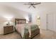 Relaxing main bedroom with a plush bed, ceiling fan, and neutral decor at 20892 Cattail Blvd, Venice, FL 34292