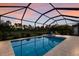 Inviting screened-in pool and spa offer a relaxing outdoor retreat with two lounge chairs at 20892 Cattail Blvd, Venice, FL 34292