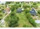 Stunning aerial view highlighting the expansive lot, mature trees, and inviting pool area at 22235 Panther Loop, Bradenton, FL 34202